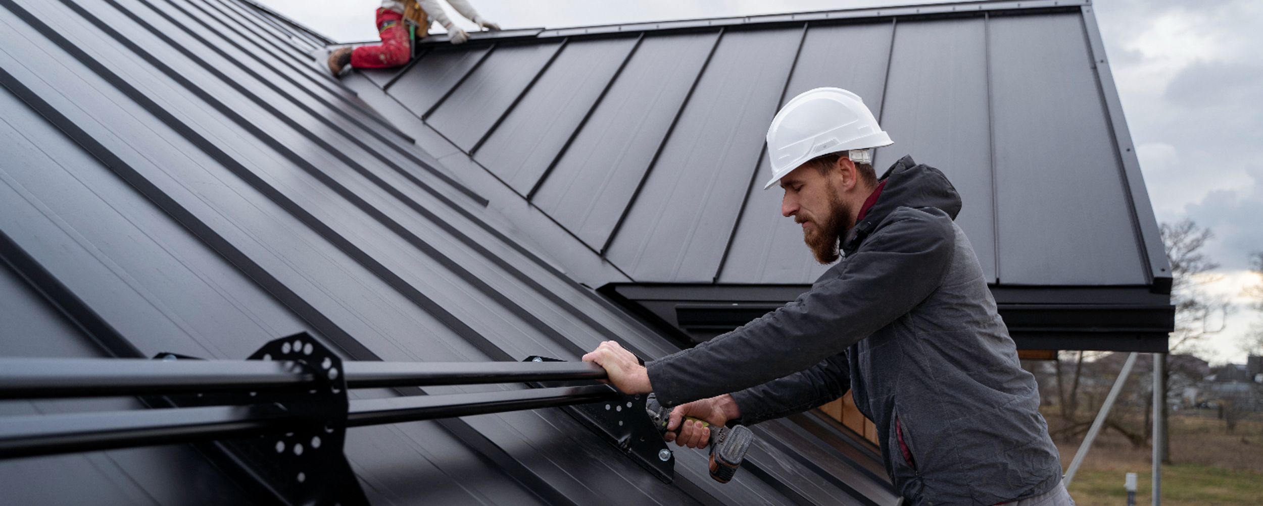 Roofer on black roof